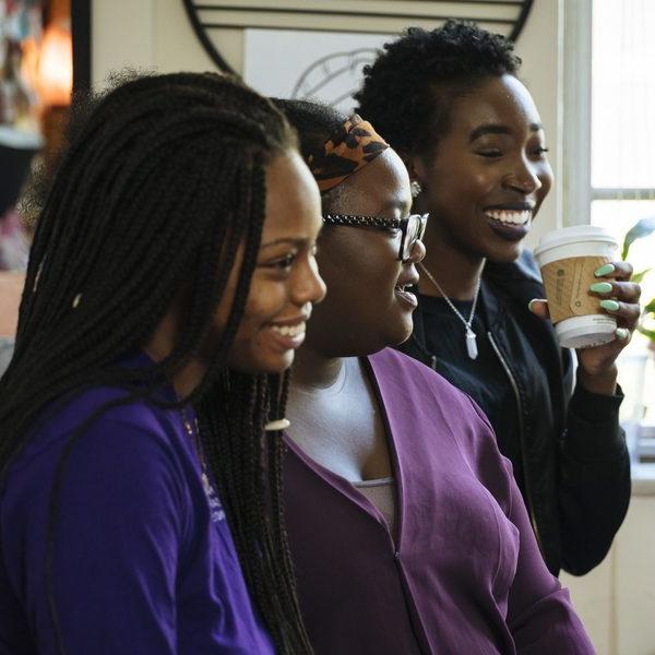 Three Africana studies major students drinking coffee at a cafe.